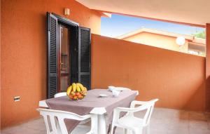 a table with a bowl of fruit on a balcony at 1 Bedroom Amazing Apartment In Costa Rei -Ca- in Costa Rei