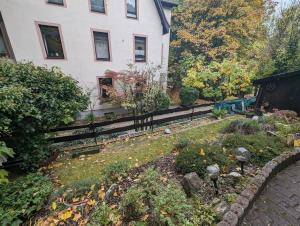 einen Garten vor einem Haus mit einem Zaun in der Unterkunft Keltenpfad-Taunus Naturnah 