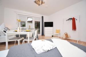 a bedroom with a table and a dining room at BA01-RI Apartment bei Bamberg in Reckendorf