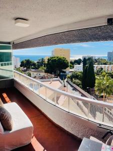 a balcony with a couch and a view of a city at Cielomar Benalmadena costa in Benalmádena