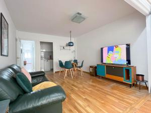 a living room with a couch and a flat screen tv at Martin´s Place in Alicante