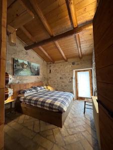 sypialnia z łóżkiem i drewnianym sufitem w obiekcie Chalet Tre Santelle w mieście Bossico
