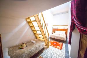 een slaapkamer met 2 stapelbedden en een ladder bij Fes Hostel Zaouia in Fès