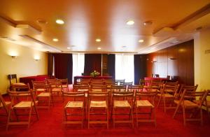 a room with rows of chairs and tables in it at Hotel Jucamar in Cangas de Morrazo