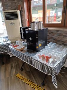 a table with cups and a coffee maker on it at Street61 Apart Hotel in Sarigerme
