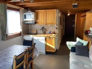 a small kitchen with a sink and a stove at Appartement dupleix - 6 personnes - Grand Bornand village in Le Grand-Bornand
