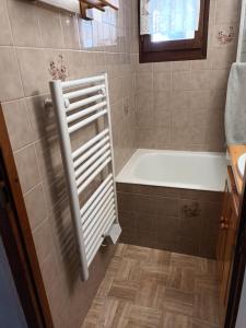 a bathroom with a bath tub and a sink at Appartement dupleix - 6 personnes - Grand Bornand village in Le Grand-Bornand