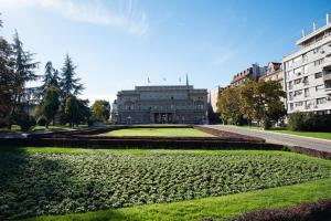 a building with a garden in front of it at Sweet House Parlament Lux in Belgrade