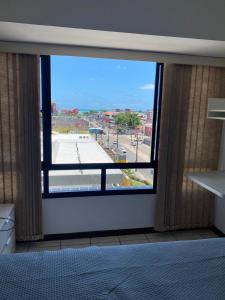 a room with a window with a view of a street at Personal Residence in João Pessoa