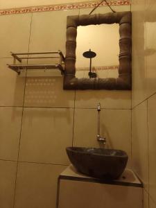 y baño con lavabo y espejo. en bucu hidden guest house, and meditation center en Payangan