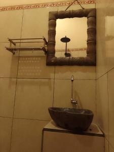 a bathroom with a sink and a mirror at bucu hidden guest house, and meditation center in Payangan