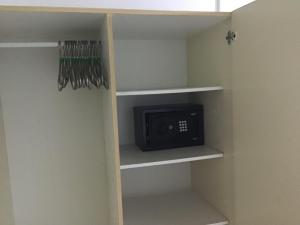 a small cabinet with a microwave in a closet at Anns Guesthouse BakauGambia in Bakau