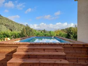 a swimming pool on the roof of a house at U MANDARINU in Ajaccio