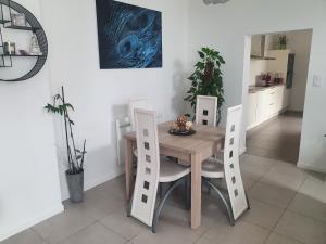een eetkamer met een houten tafel en stoelen bij Sweety house in Brive-la-Gaillarde