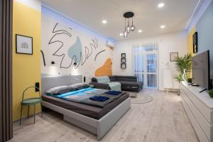 a bedroom with a bed and a living room at Centre point Apartment in Budapest