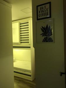 a room with a refrigerator with a bed in it at AIPA HOSTEL.COM in Cabo Frio