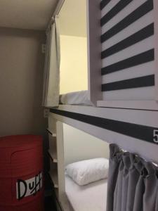 a bedroom with a bunk bed with a mirror at AIPA HOSTEL.COM in Cabo Frio