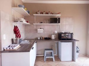 a small kitchen with a counter and a sink at Sally's Tranquil Airbnb in Centurion