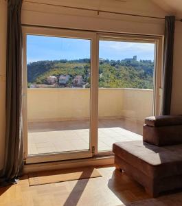a room with a large window with a view at Luxury Penthouse in Široki Brijeg