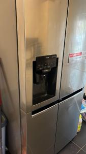 a stainless steel refrigerator with a microwave at Mobilierte 5 Zimmer Wohnung zur vermieten in Frankfurt