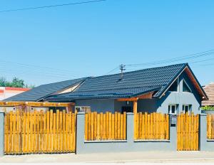 a house with a yellow fence in front of it at Villa 3 in Mediaş