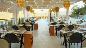 a row of tables and chairs in a restaurant at Xen Deluxe Boutique Hotel And Restaurant in Marmaris