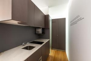 a kitchen with a sink and a counter top at Pensao O Laranjeira in Viana do Castelo
