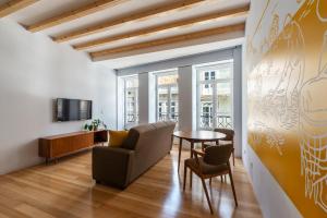 a living room with a couch and a table at Pensao O Laranjeira in Viana do Castelo