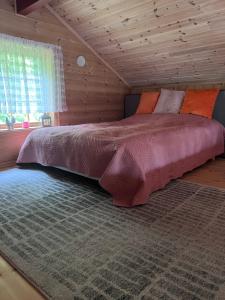 a bedroom with a large bed in a log cabin at Domek Iwony in Molde +19 photos