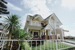 a white fence in front of a house at Cozy crib in Saratoga with Jacuzzi in Tagaytay