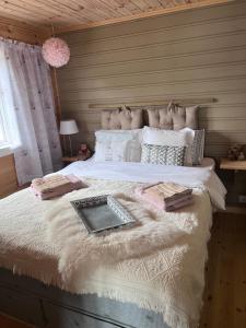 a bedroom with a large bed with a keyboard on it at Domek Iwony in Molde