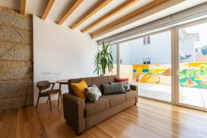 a living room with a couch and a table at Pensao O Laranjeira in Viana do Castelo