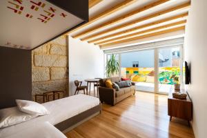 een slaapkamer met een bed en een woonkamer bij Pensao O Laranjeira in Viana do Castelo +37 foto's