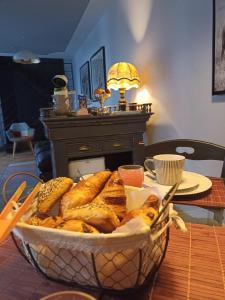 a basket of bread sitting on a table at La Suite 14 in Cholet