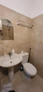 a bathroom with a white toilet and a sink at Agroni Rooms-21 in Tirana