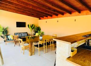a dining room with a wooden table and chairs at Villa 112 in Dîrlos