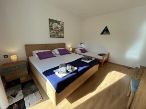 a bedroom with a large bed with purple pillows at Apartment Vitezic in Punat +9 photos