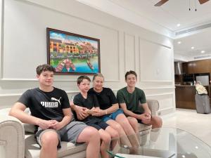 a group of people sitting on a couch at Luxury Apartment - Rooftop Swimming Pool - Beach Front - Hinata Apartment in Danang +54 photos