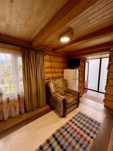a living room with a couch and a refrigerator at Садиба BETWEEN MOUNTAINS in Mizhhirʼʼya