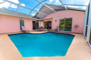 a swimming pool in a house with a glass ceiling at Home in davenport Cheerful 4-bedroom with pool in Davenport