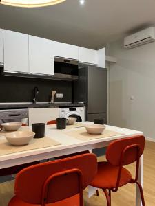 a kitchen with a counter with bowls on it at Exyca Plaza Castilla in Madrid