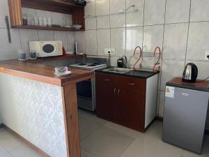 a small kitchen with a sink and a stove at Relax IV in Paysandú