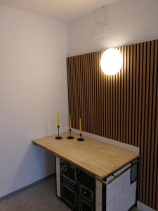 a room with a wooden counter with two candles on it at Historische Villa im Herzen Rankweils in Rankweil