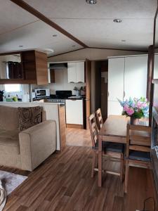 a kitchen and living room with a table and a couch at Holiday Cottage Seaside in Knokke-Heist