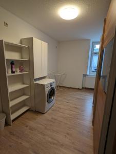 a laundry room with a washing machine in it at Ferienwohnung 1 in Schlettau