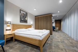 a bedroom with a large bed in a room at Rzemieślnik Zakopane in Zakopane