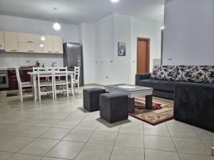 a living room with a couch and a table at Siar Apartment in Tirana