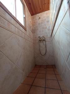 a walk in shower in a bathroom with a window at Casa Rural La Yedra San Mateo in Arbejales +85 photos