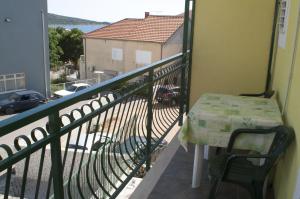 a balcony with a table and a view of a street at Apartments Jadrijević Brne in Primošten