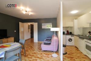 a living room with a purple chair and a kitchen at LE CORVETTE 1 - 4 COUCHAGES in Carry-le-Rouet +5 photos